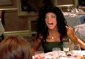 Teresa from the Housewives of New Jersey flipping a table screaming Prostitution Whore!